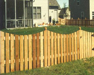 scalloped wood fence with decorative posts